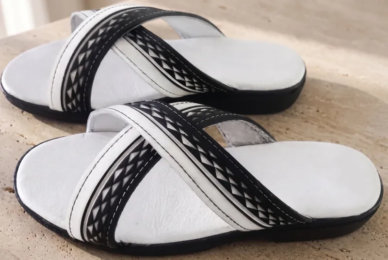 A pair of Za Sandals on a stone step